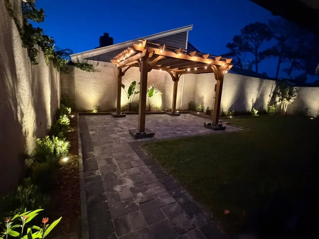 Outdoor patio with pavers and landscape lighting in Jacksonville Beach home