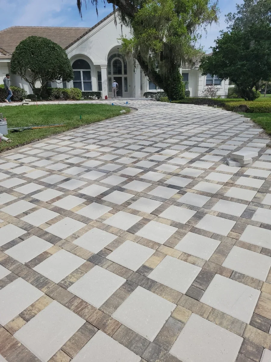 Geometric paver driveway with light gray and charcoal pavers in diamond pattern