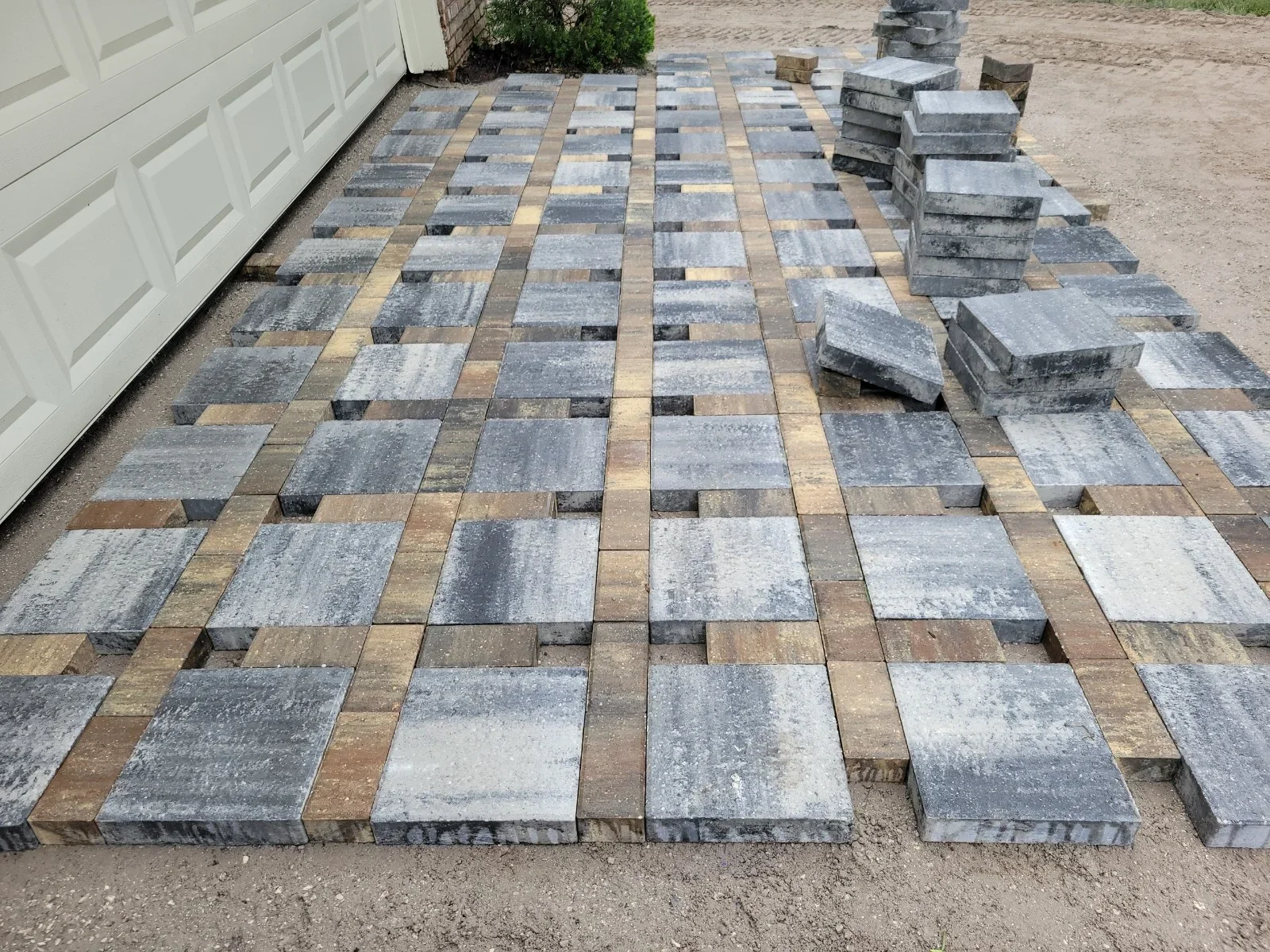 Gray and tan permeable pavers in running bond pattern with polymeric sand joints
