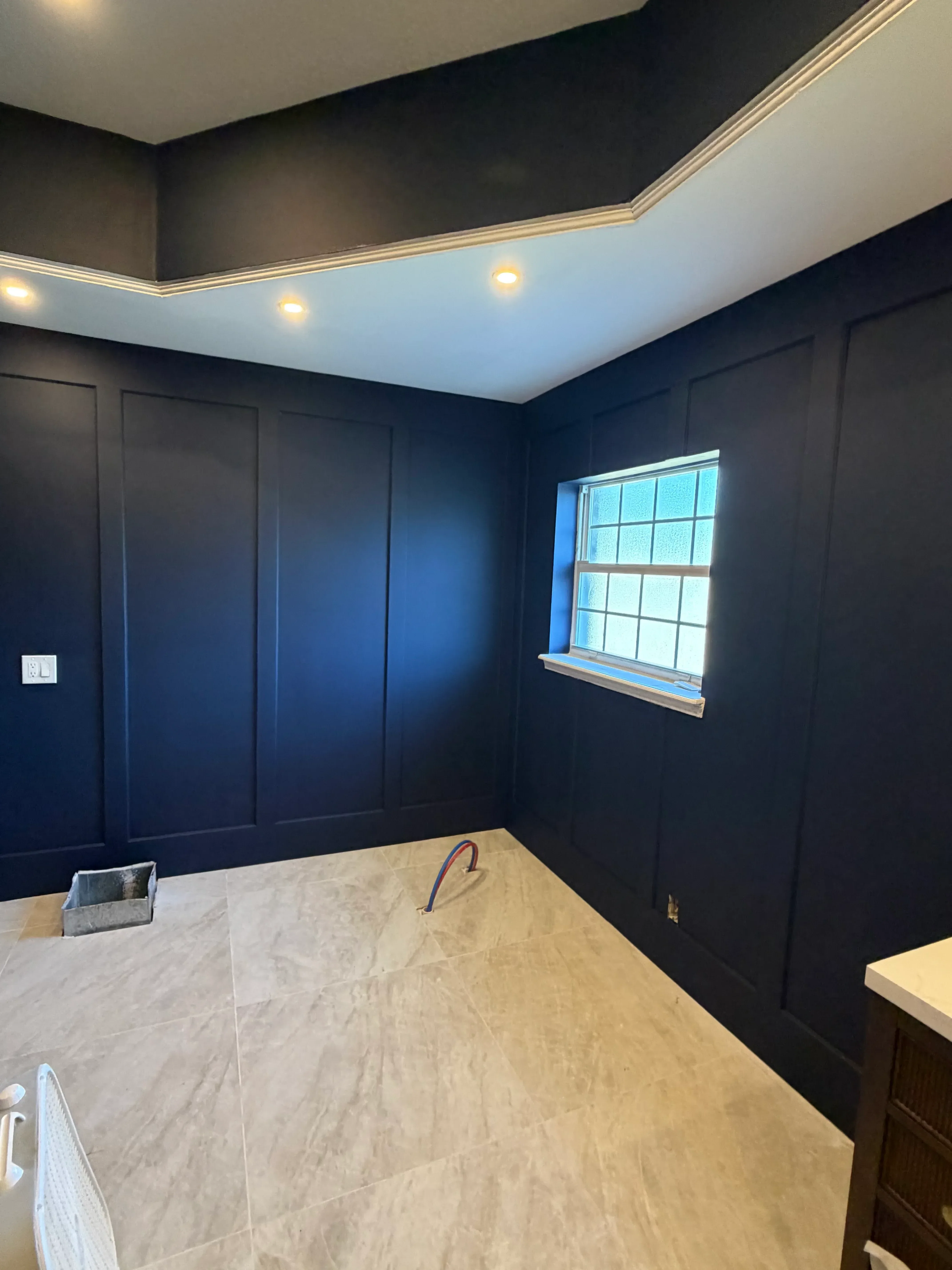 Skylight installation in vaulted ceiling with drywall finishing and recessed lighting