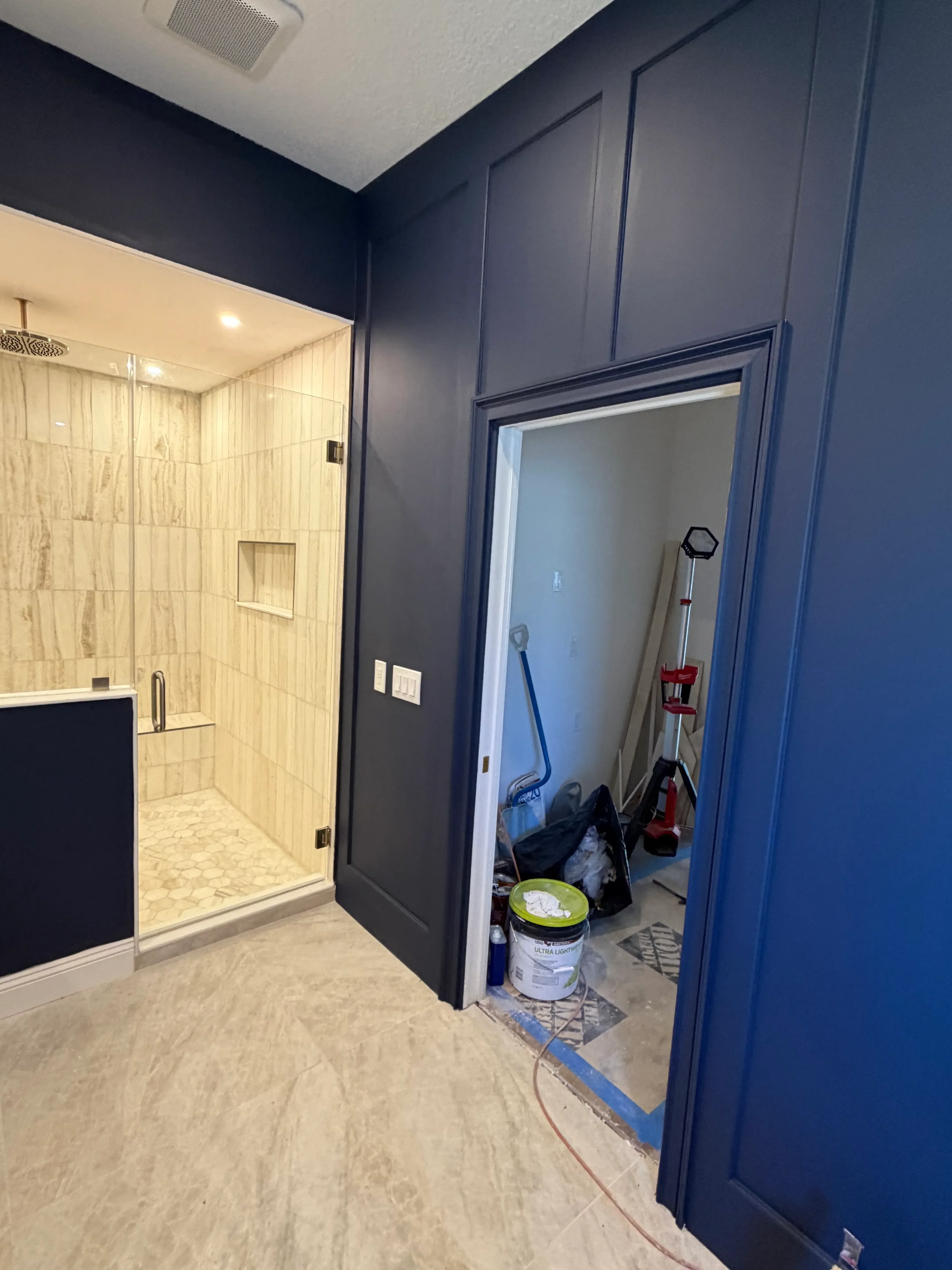 Bathroom interior with blue ceiling, recessed lights, ceramic tile flooring, and white walls